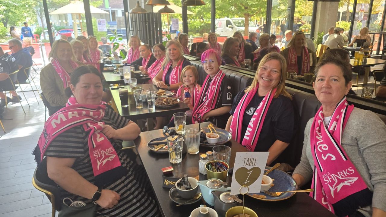 Match of the Dames participants wearing pink football scarves before a match