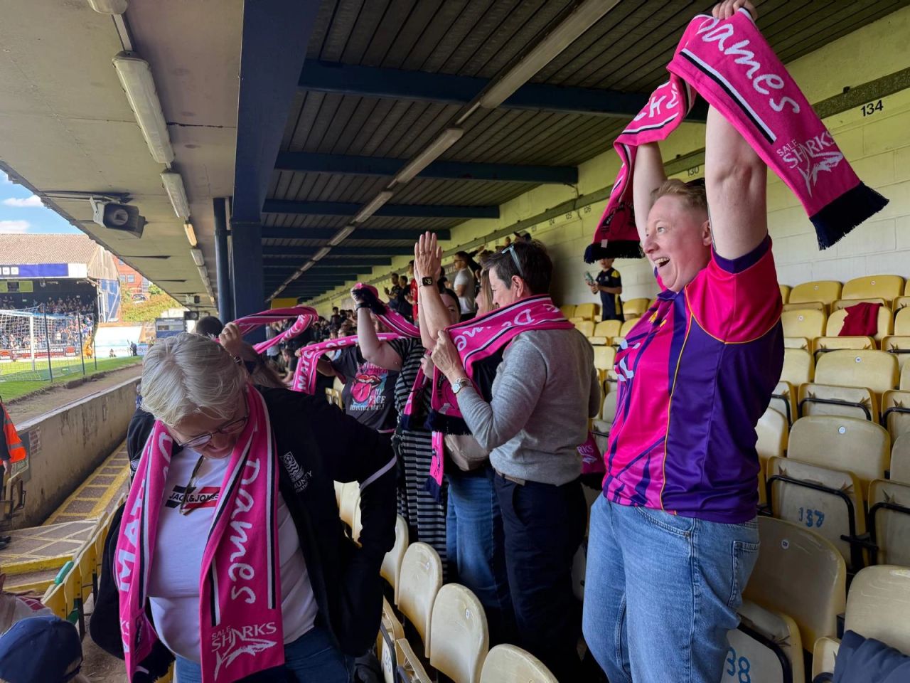 Match of the Dames participants wearing pink football scarves before a match